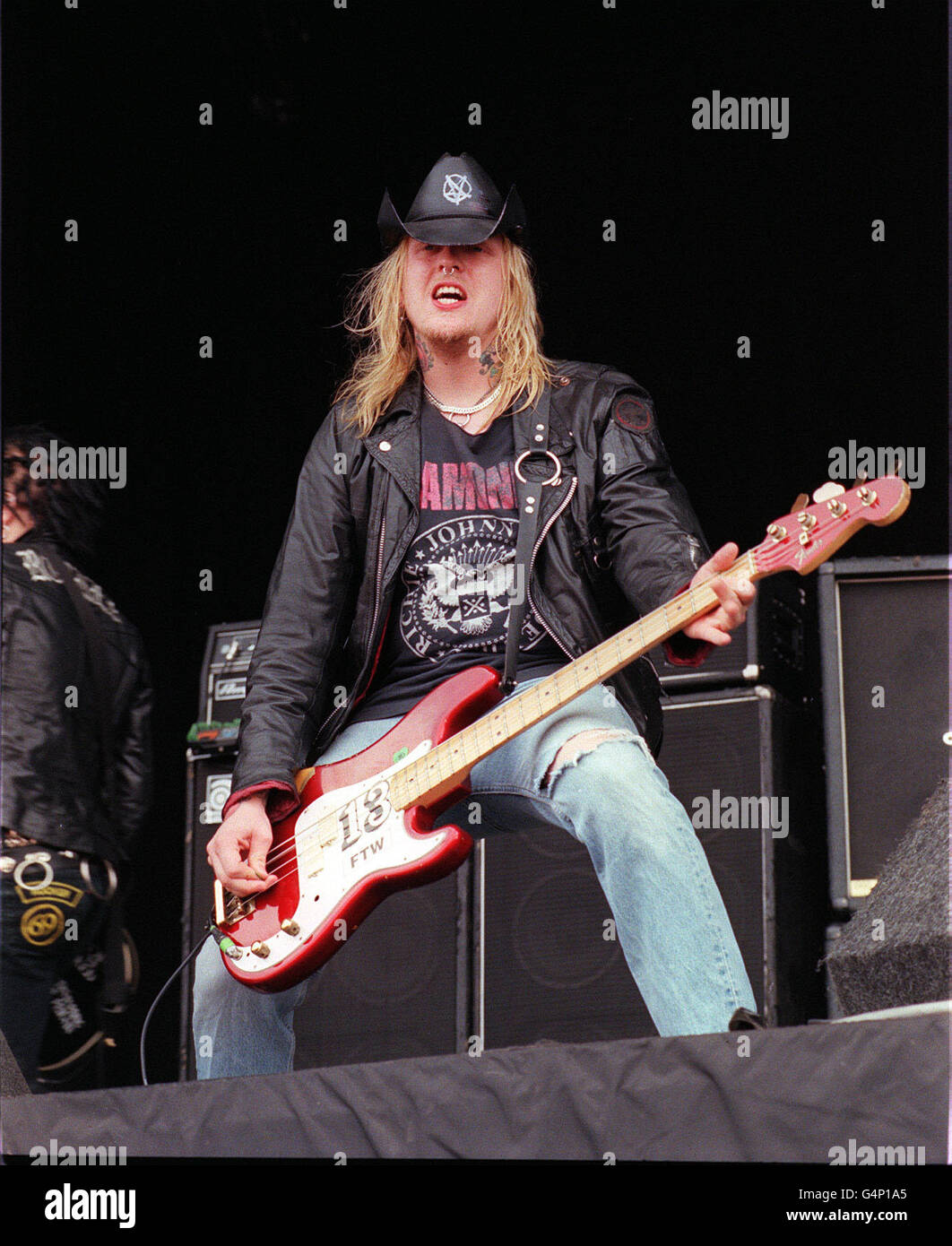 A member of the band Backyard Babies performing on stage at the Reading