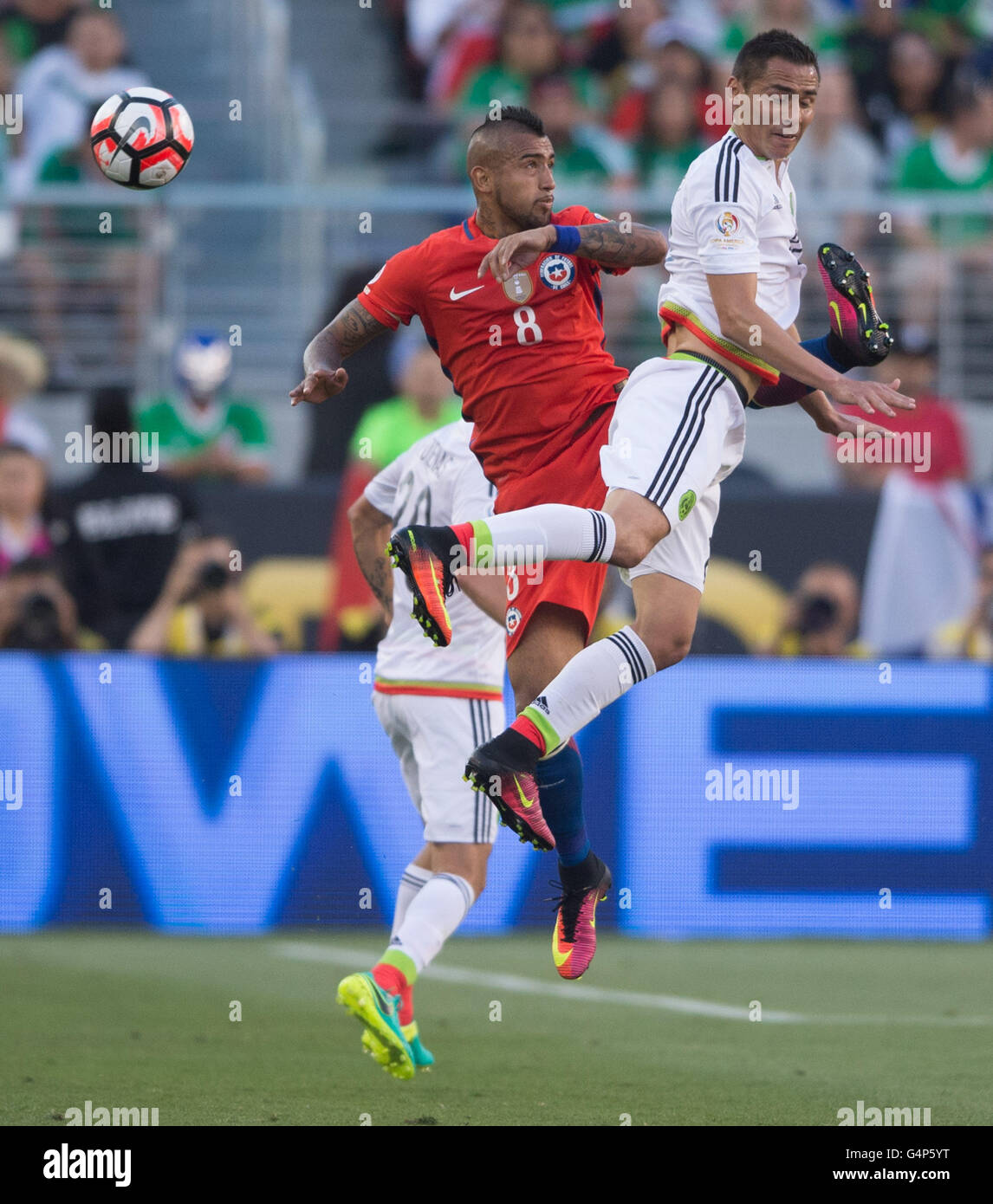 Santa Clara, USA. 18th June, 2016. Arturo Vidal (L) of Chile vies with Paul Aguilar of Mexico during their quarterfinal match of 2016 Copa America soccer tournament at the Levi's Stadium in Santa Clara, California, the United States, June 18, 2016. Chile won 7-0. Credit:  Yang Lei/Xinhua/Alamy Live News Stock Photo