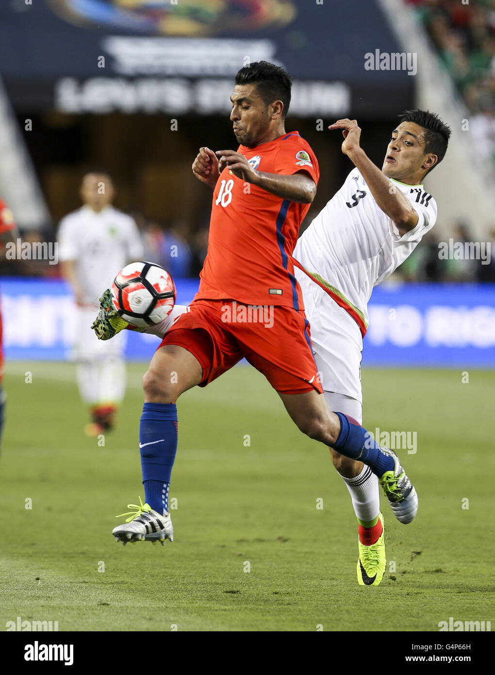Los Angeles, California, USA. 18th June, 2016. Chile defender Gonzalo Jara #18 vies the ball against Mexico forward Raul Jimenez #9 in the Copa America soccer match between Mexico and Chile at the Levi's Stadium in Santa Clara, California, June 18, 2016. Chile won 7-0. Credit:  Ringo Chiu/ZUMA Wire/Alamy Live News Stock Photo