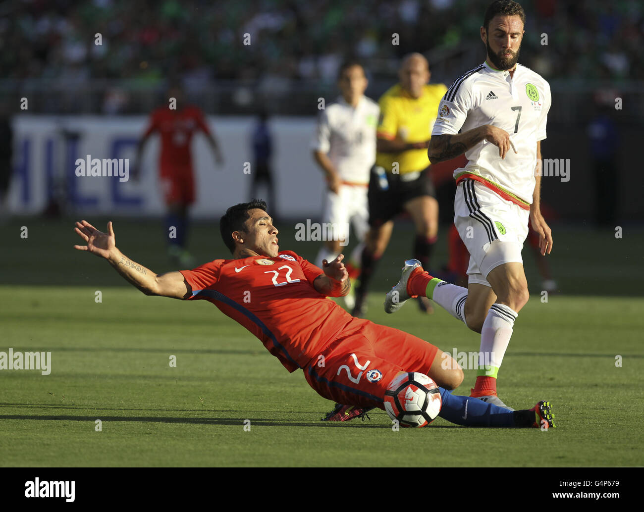Los Angeles, California, USA. 18th June, 2016. Chile forward Edson Puch #22 slides to the ball against Mexico defender Miguel Layun #7 in the Copa America soccer match between Mexico and Chile at the Levi's Stadium in Santa Clara, California, June 18, 2016. Chile won 7-0. Credit:  Ringo Chiu/ZUMA Wire/Alamy Live News Stock Photo