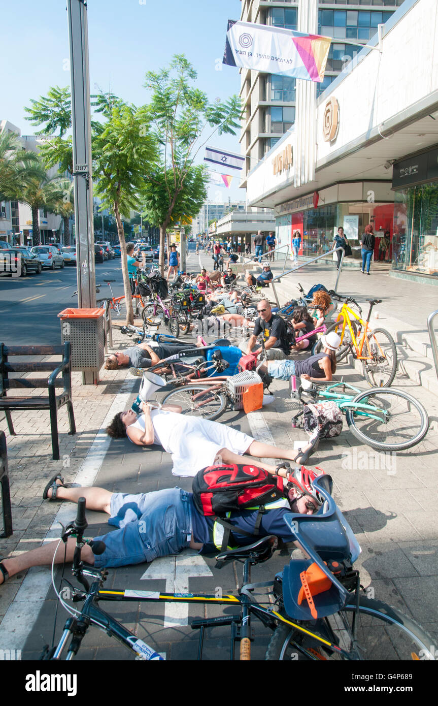Tel Aviv, Israel. 19th June, 2016. flash mob in Tel Aviv, Israel Cyclists lie on the alleged bicycle lane under the municipality building protesting the lack of adequate infrastructure for safe cycling in the city. The Tel Aviv-Jaffa municipality (Mayor Ron Huldai) claims 150 km of bicycle lanes but most of them are just a white line on the sidewalk causing friction between pedestrians and cyclists Credit:  PhotoStock-Israel /Alamy Live News Stock Photo