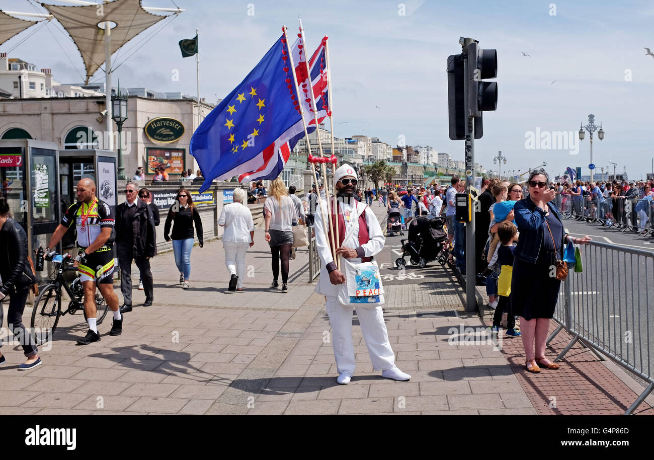 Brighton, UK. 19th June, 2016. With only a few days until the EU Referendum vote in Britain this man promoting peace took to Brighton seafront with a European Flag a Flag of St George and the Union Flag of Britain .   Credit:  Simon Dack/Alamy Live News Stock Photo