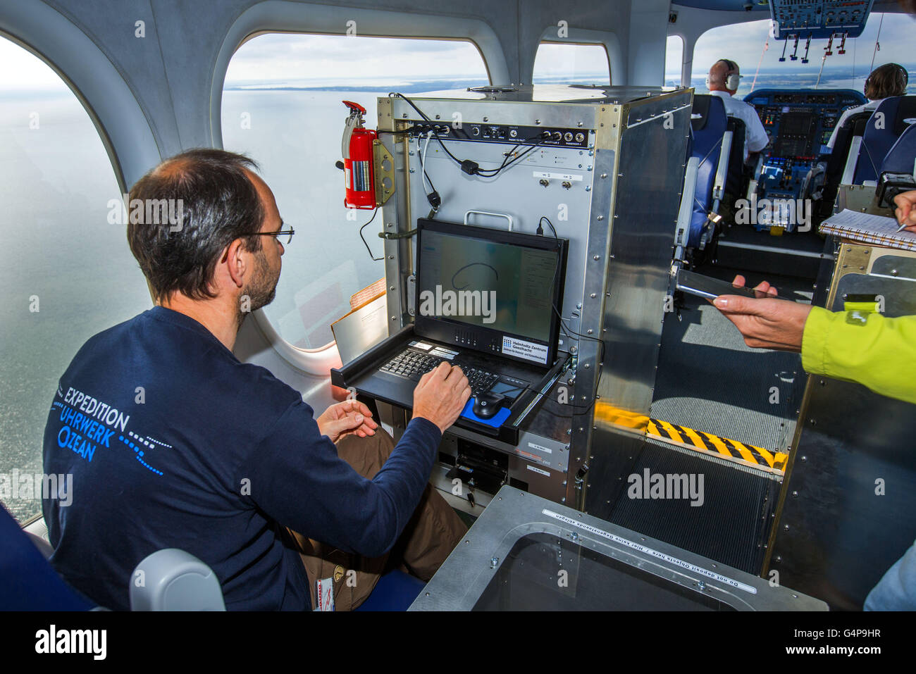 Geesthacht, Germany. 19th June, 2016. In the control centre of a zeppelin the biological oceanographer Ruediger Roettgers works during a measurement flight over the Baltic Sea from the Peenemuende airfield in Peenemuende, Germany, 19 June 2016. The incoming measurements belong to an expedition for the research of marine vortices. The 75-meter-long airship is equipped with special high-resolution cameras, with which the smallest temperature differences of 0.03 degrees and colour differences can be registered in the water. The researchers collect data on the influence of unstable small sea swirl Stock Photo