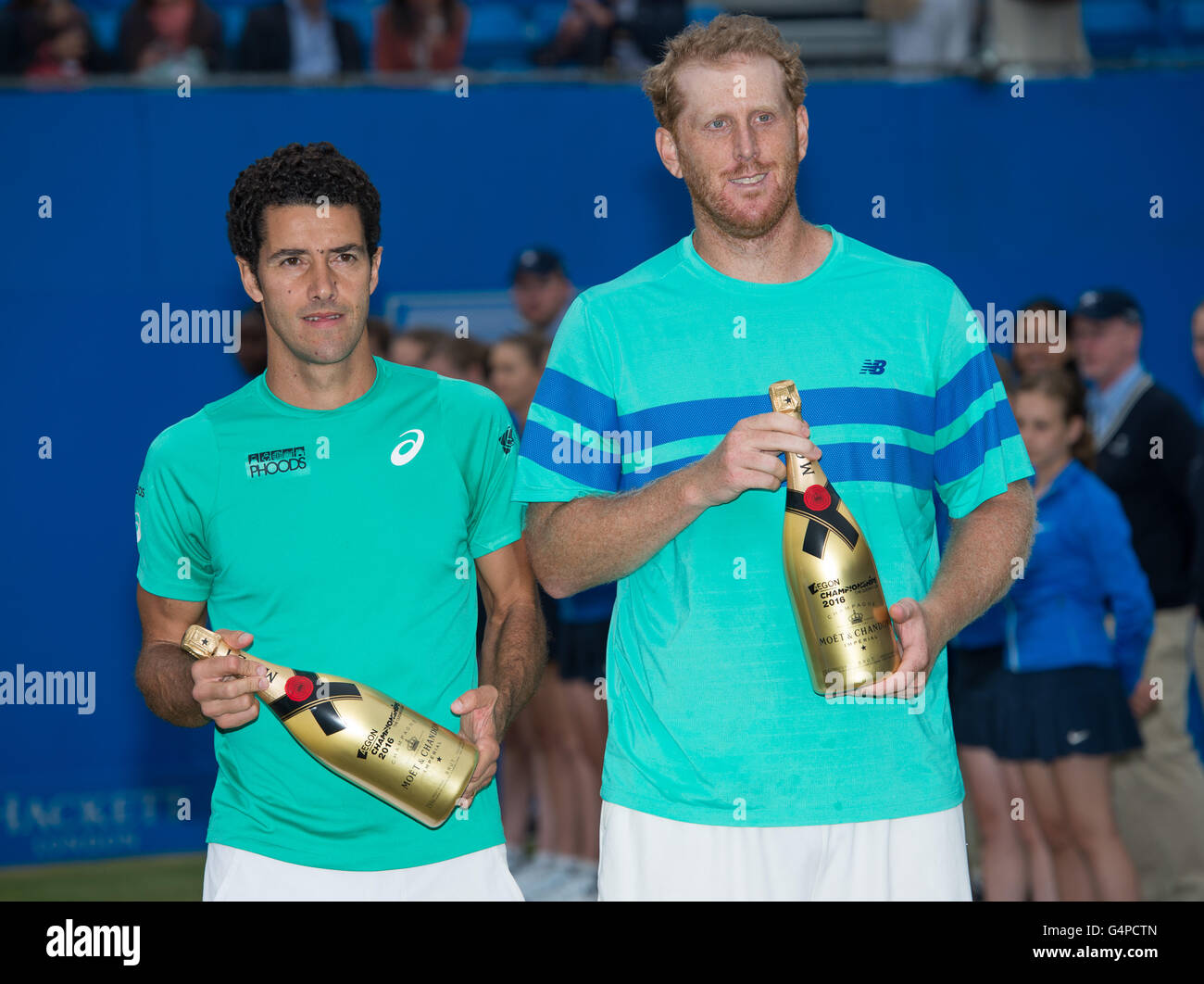London, UK. 19th June, 2016. Runners-up Chris Guccione (R) of Australia and Andre Sa of Brazil pose for photos during the victory ceremony for the Men's Doubles final with Nicolas Mahut and Pierre-Hugues Herbert of France on day seven of the ATP-500 Aegon Championships at the Queen's Club in London, Britain on June 19, 2016. © Jon Buckle/Xinhua/Alamy Live News Stock Photo