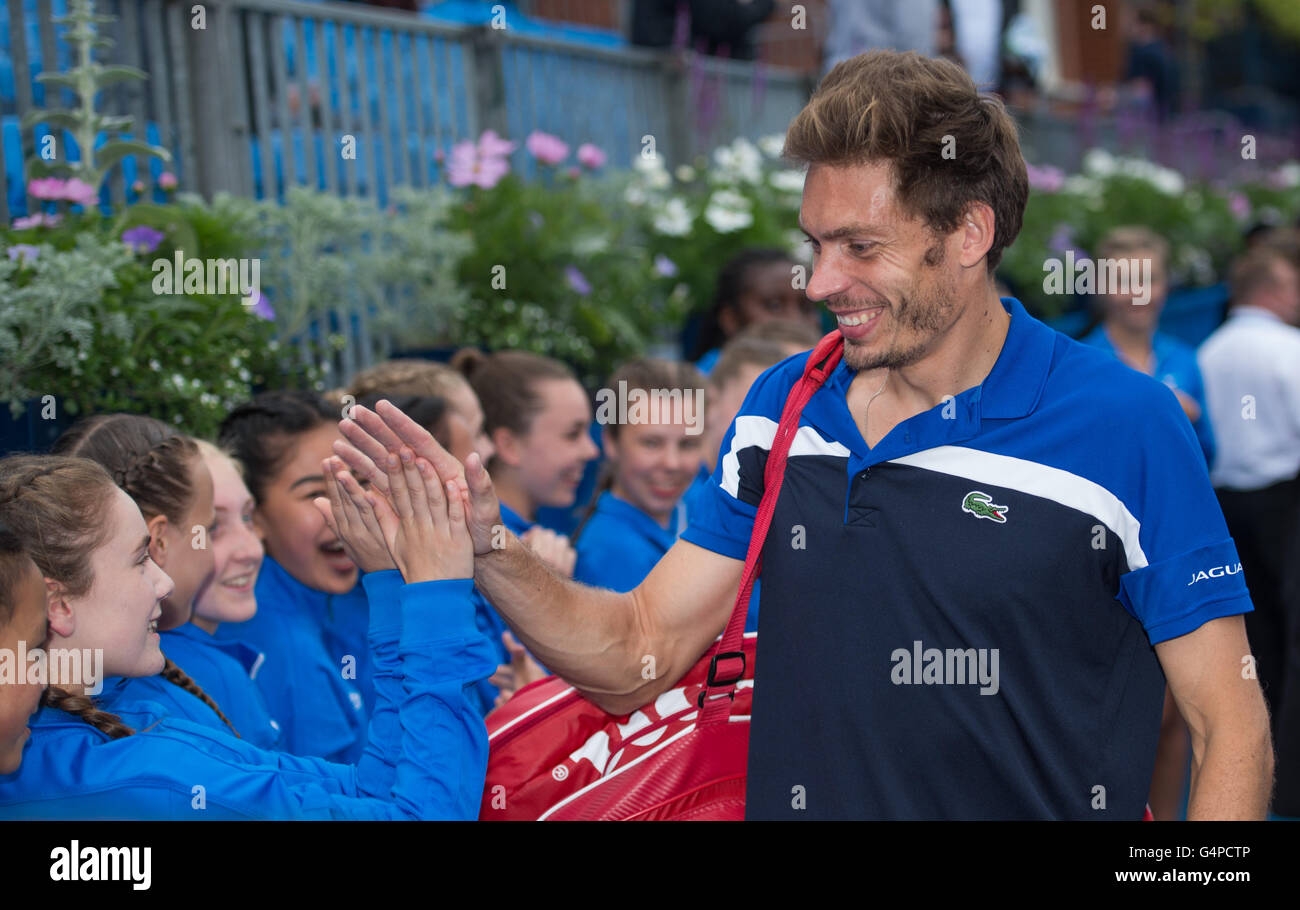 London, UK. 19th June, 2016. Nicolas Mahut of France is congratulated by ball girls after victory against Chris Guccione of Australia and Andre Sa of Brazil during the Men's Doubles final on day seven of the ATP-500 Aegon Championships at the Queen's Club in London, Britain on June 19, 2016. © Jon Buckle/Xinhua/Alamy Live News Stock Photo
