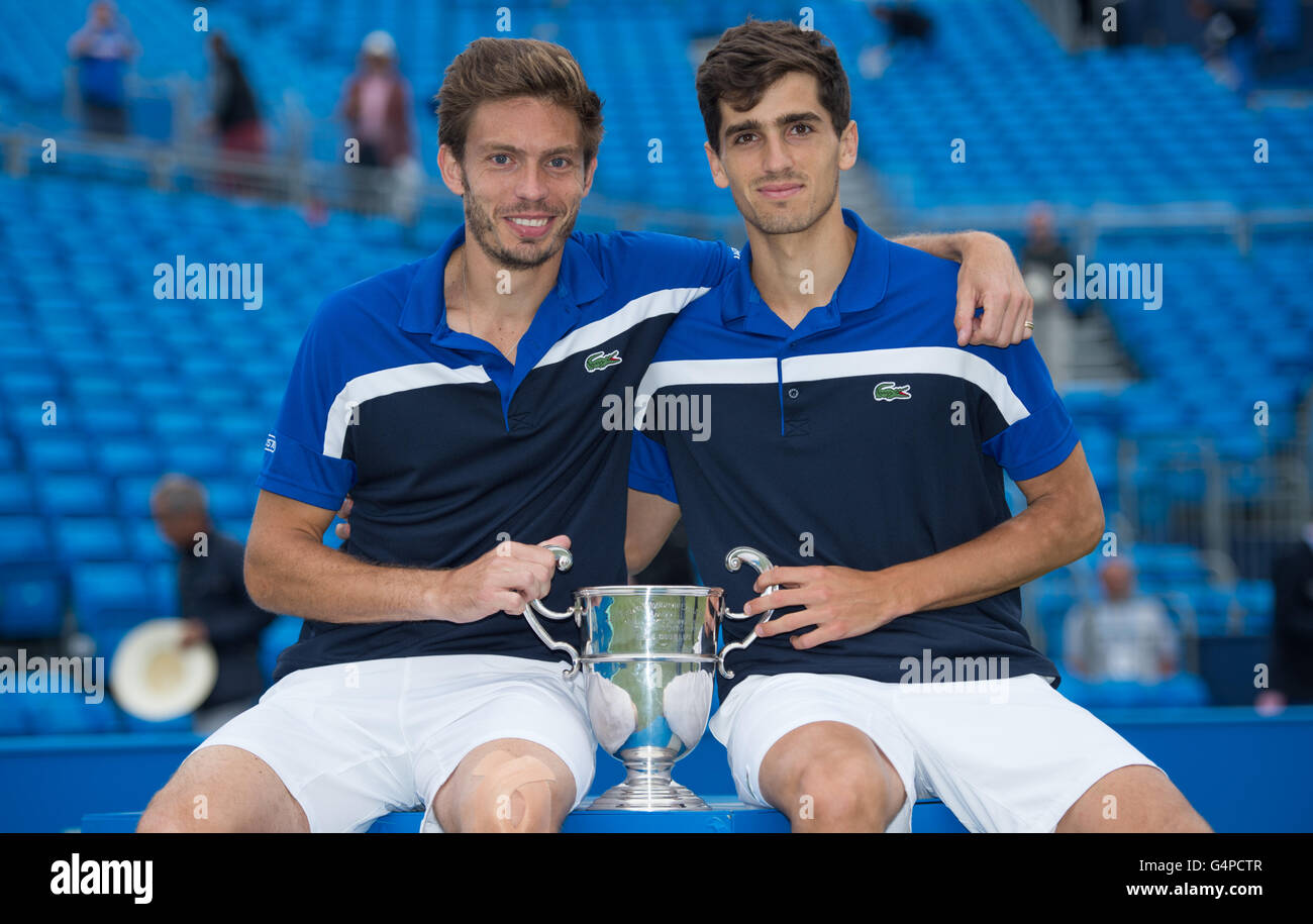 London, UK. 19th June, 2016. Nicolas Mahut (L) and Pierre-Hugues Herbert of France lift the Men's Doubles Trophy after victory against Chris Guccione of Australia and Andre Sa of Brazil during the Men's Doubles final on day seven of the ATP-500 Aegon Championships at the Queen's Club in London, Britain on June 19, 2016. © Jon Buckle/Xinhua/Alamy Live News Stock Photo