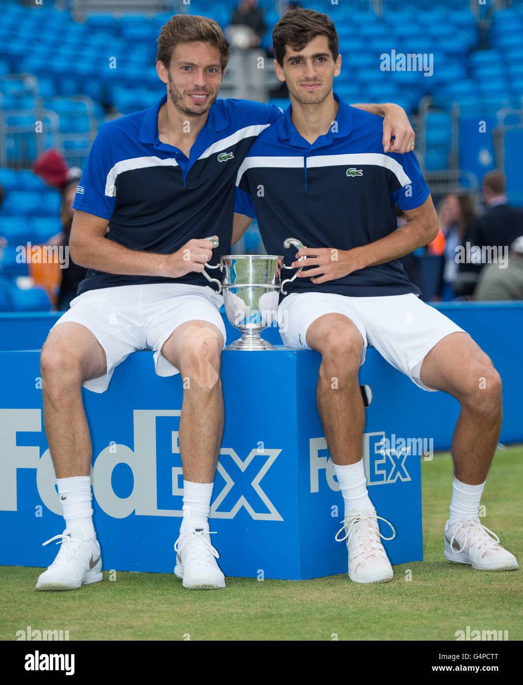 London, UK. 19th June, 2016. Nicolas Mahut (L) and Pierre-Hugues Herbert of France lift the Men's Doubles Trophy after victory against Chris Guccione of Australia and Andre Sa of Brazil during the Men's Doubles final on day seven of the ATP-500 Aegon Championships at the Queen's Club in London, Britain on June 19, 2016. © Jon Buckle/Xinhua/Alamy Live News Stock Photo