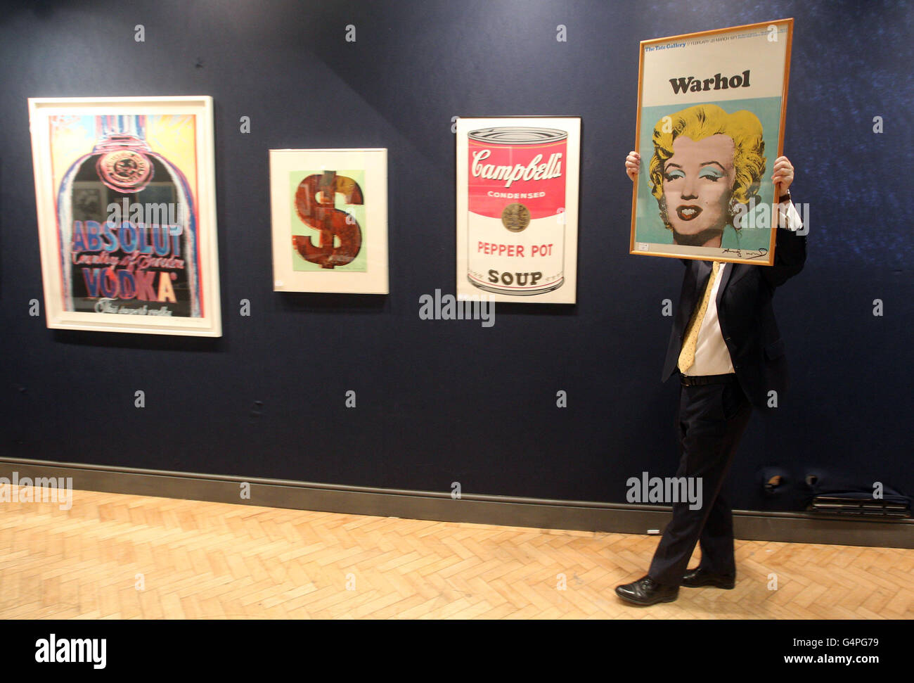 A gallery worker carries a signed print entitled 'Marilyn Monroe' by Andy Warhol estimated to fetch &pound;1,500 at Bonhams in their print auction in London. Stock Photo