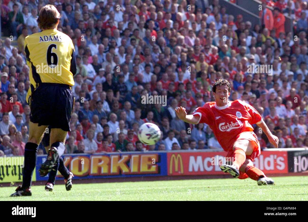 Liverpool's Robbie Fowler powers the ball past the Arsenal defence to score during a Premiership match at Anfield. Stock Photo