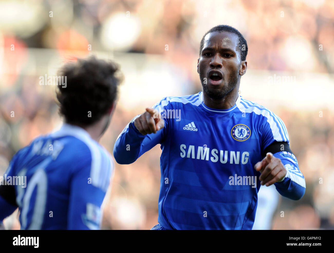 Chelsea's Didier Drogba celebrates scoring the opening goal with Juan Mata (left) during the Barclays Premier League match at Sport Direct Arena, Newcastle. Stock Photo