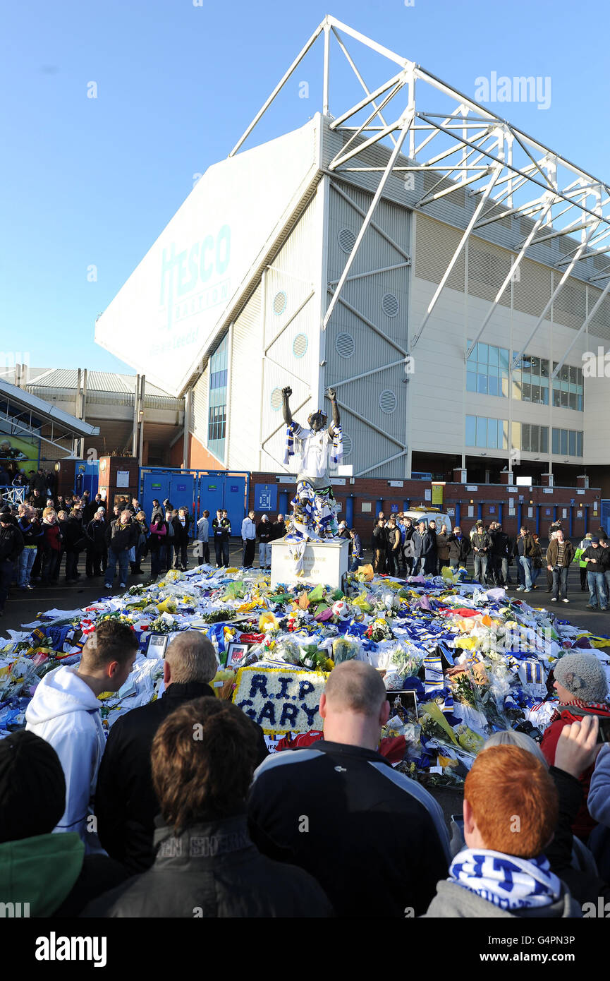 Fans stand around the shrine to Gary Speed, at the Billy Bremner statue