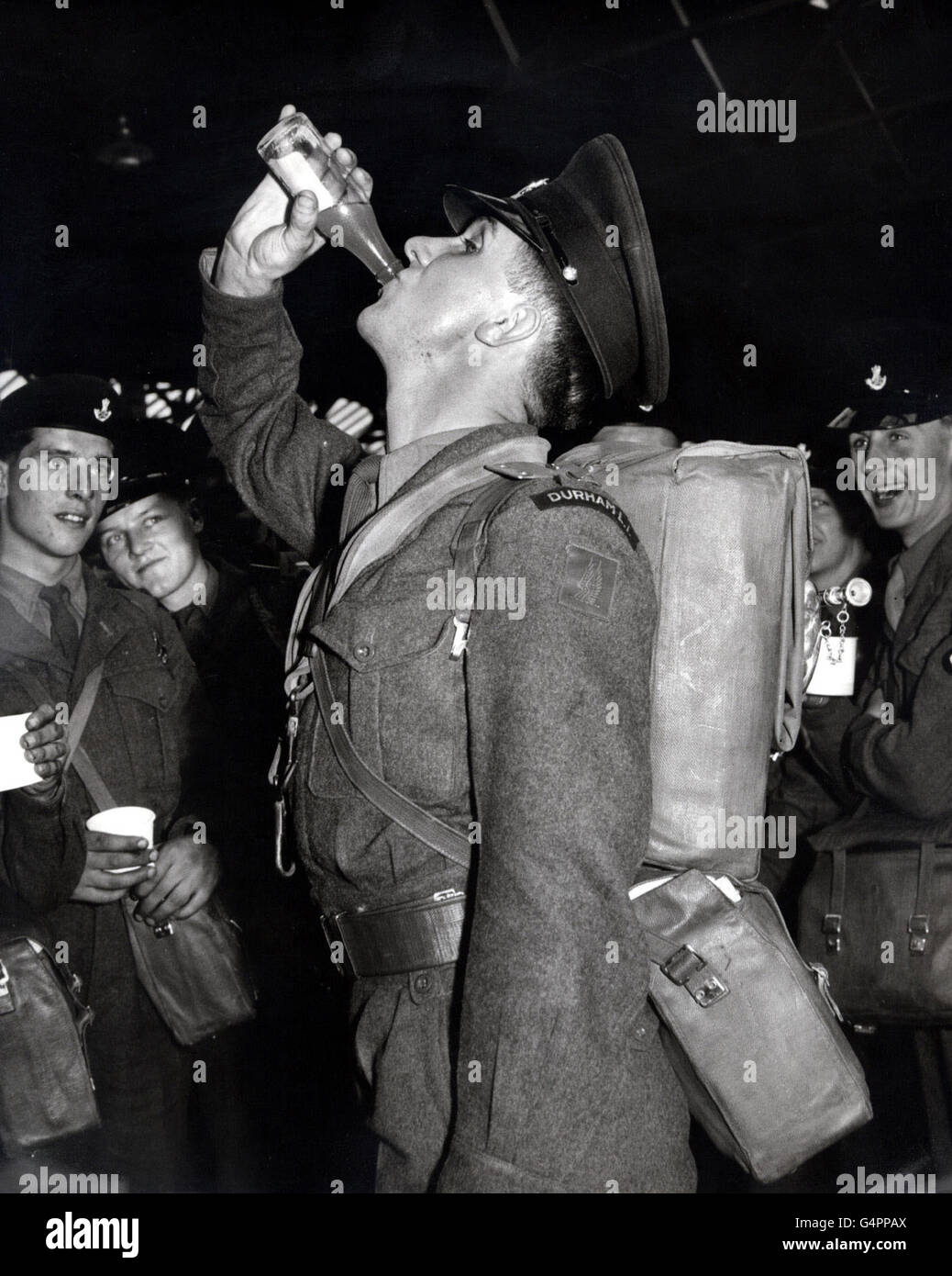 Bugler John Gay, Durham Light Infantry, drinks his lemonade before leaving Southampton on the troopship Devonshire for Cyprus. Stock Photo