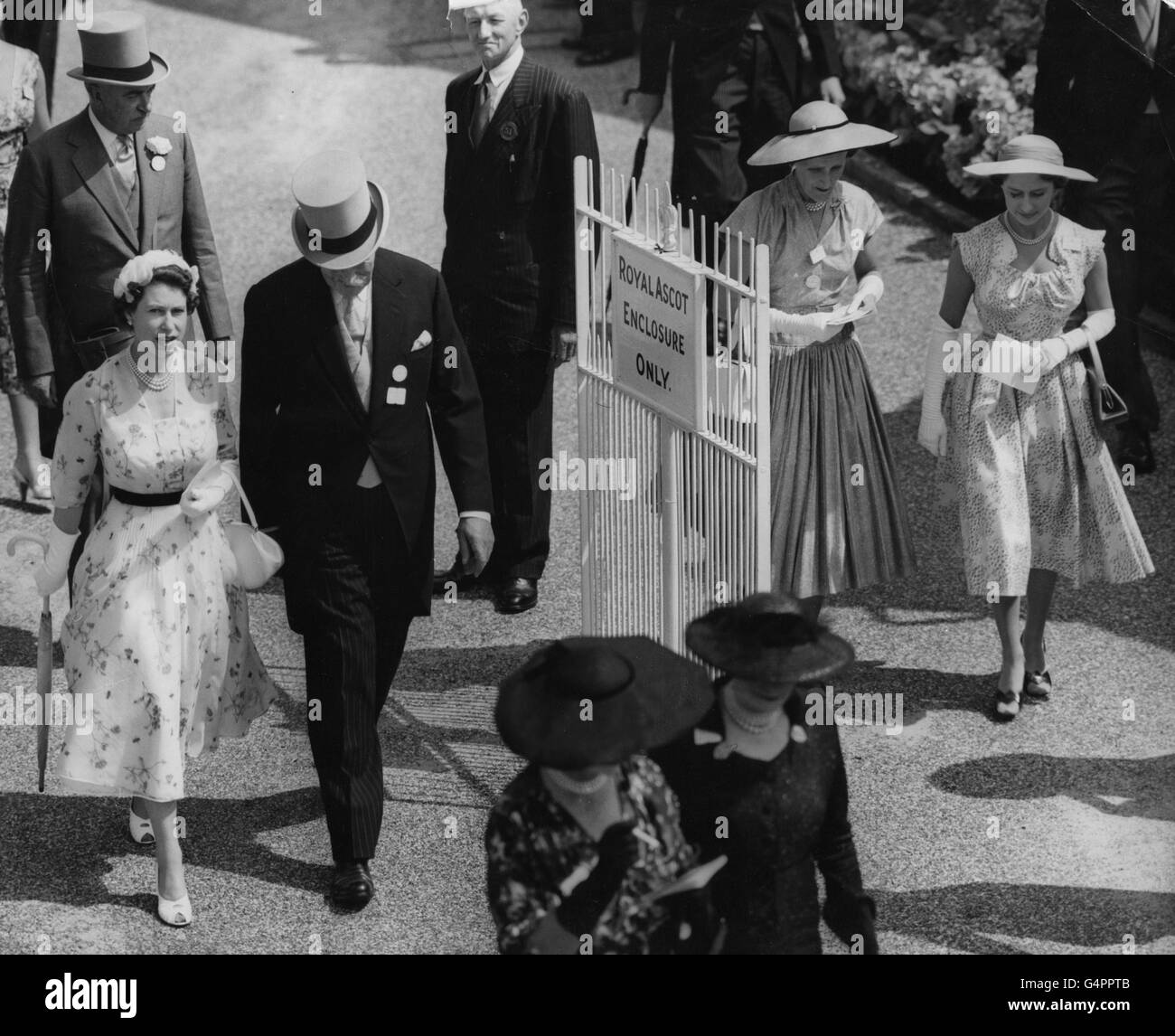 Queen Elizabeth II and Princess Margaret, right, walk to the paddock at the Royal Ascot race meeting. Stock Photo