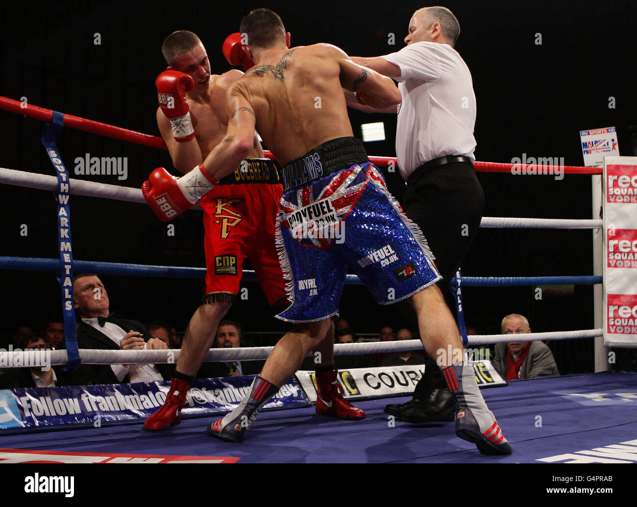 The referee steps in to stop the fight between Steve Williams (left