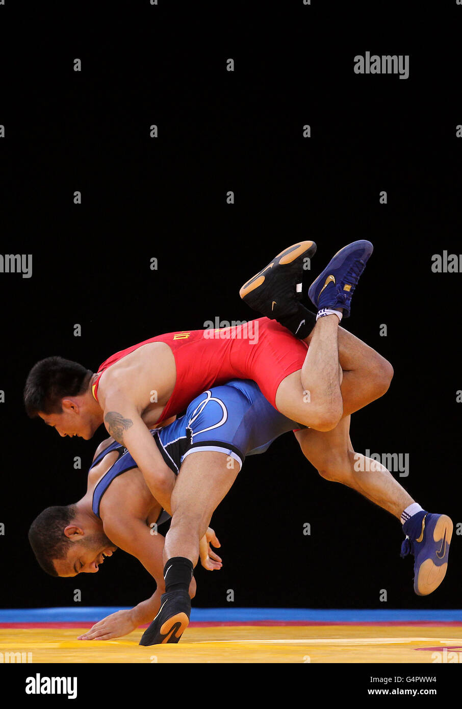 The USA's Angel Escobedo (bottom) in action against China's Qi Mude during the London Olympic Games 2012 Test Event at the Excel Arena, London. Stock Photo
