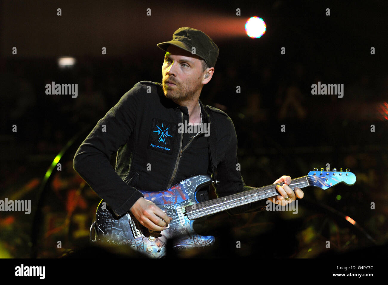 Guitarist Johnny Buckland, of Coldplay performs as they promote their fifth studio album, Mylo Xyloto, released earlier this year, at The O2 Arena, Greenwich, south London. Stock Photo