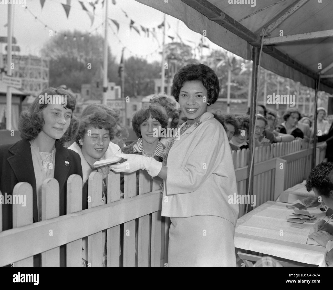 Welsh singer Shirley Bassey signs autographs for fans at the opening of Battersea fun fair. Stock Photo