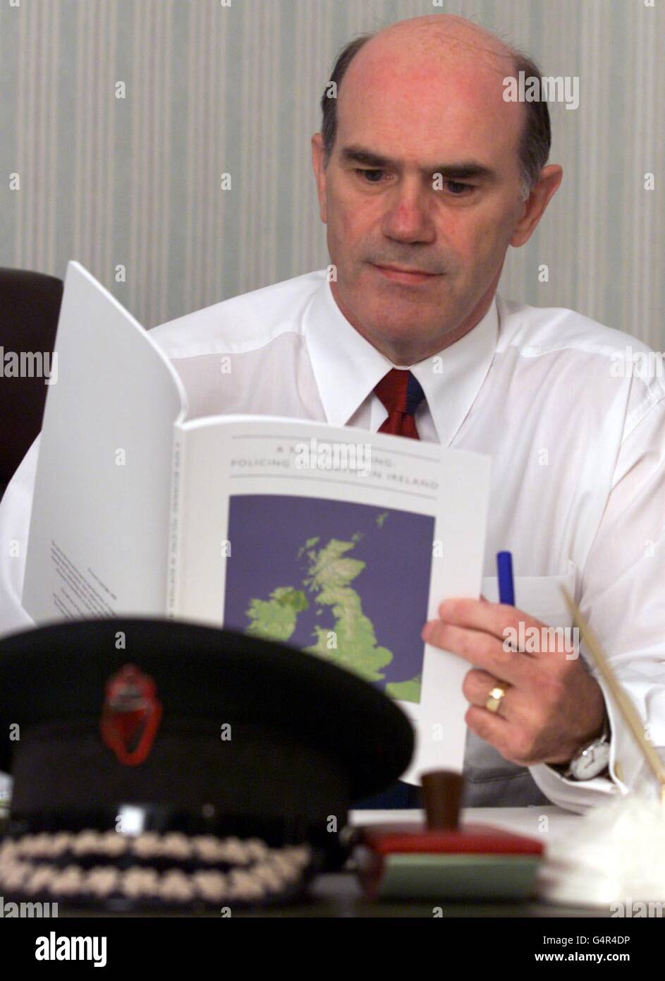 Royal Ulster Constabulary's Chief Constable Sir Ronnie Flanagan looks over the Patten report into the reform of the RUC at his office at RUC Headquarters in Belfast. Stock Photo