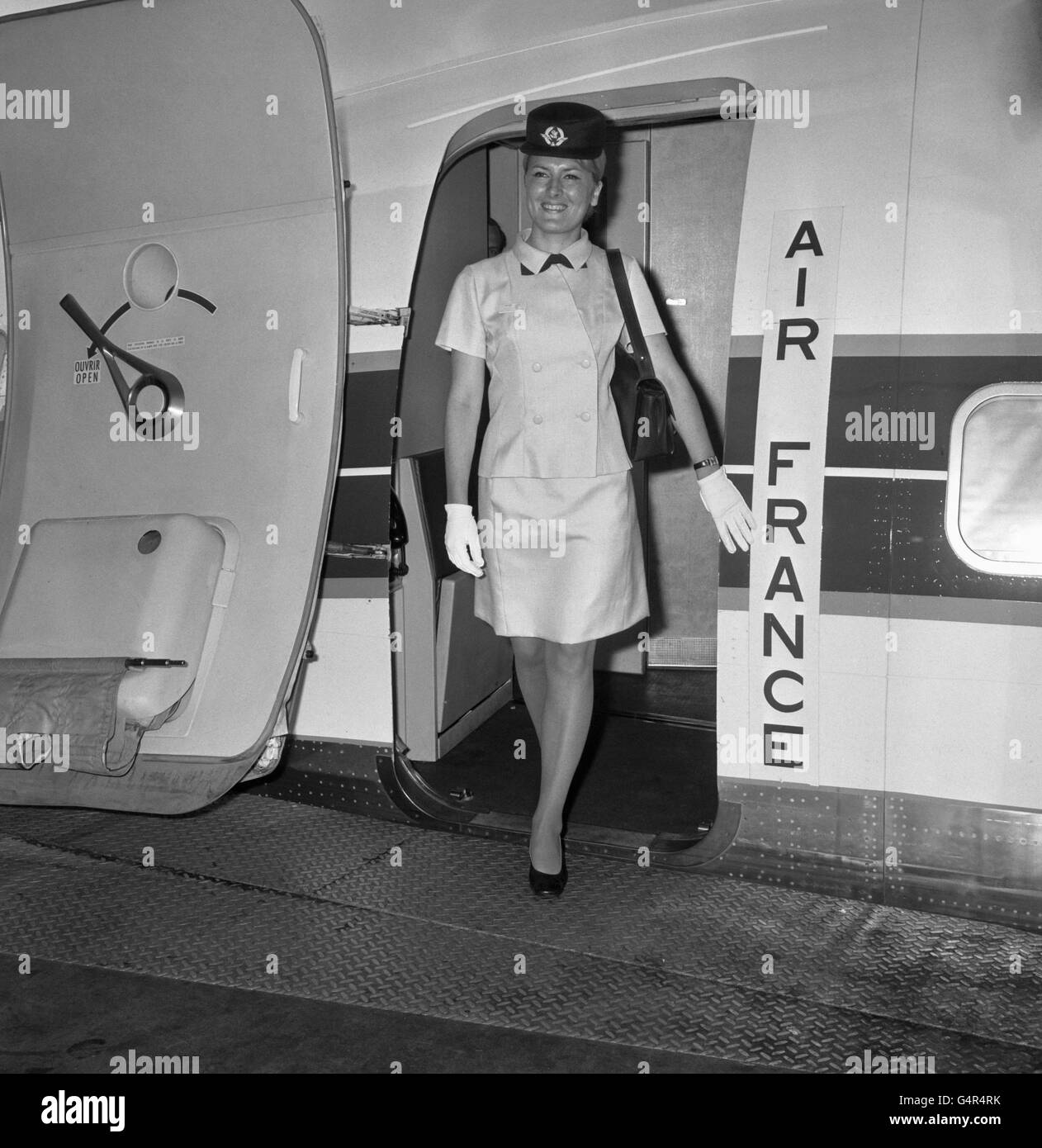 Air France hostesses, Francois Baudoin, 24, wearing for the first today the  new Air France uniform in blue designed by Balenciaga. Pink outfits are  also available. All their hats are in navy