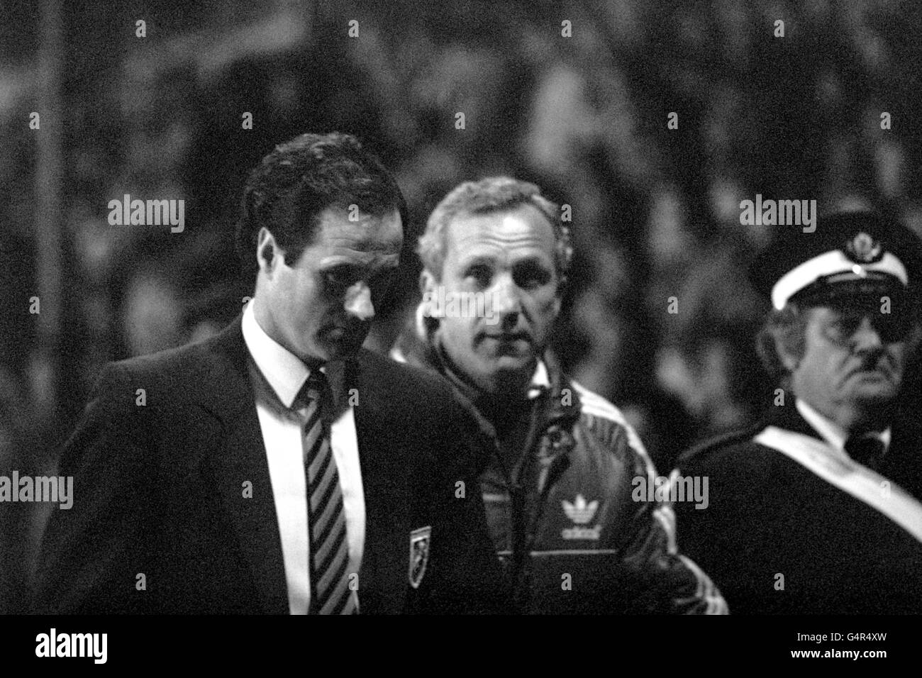 Millwall Manager George Graham (l) and his assistant Theo Foley in a dejected mood after the match was halted when fans spilled on to the pitch. Millwall fans had invaded the pitch half an hour before the kick off, returning to the terraces after a personal pleas from George Graham. Stock Photo