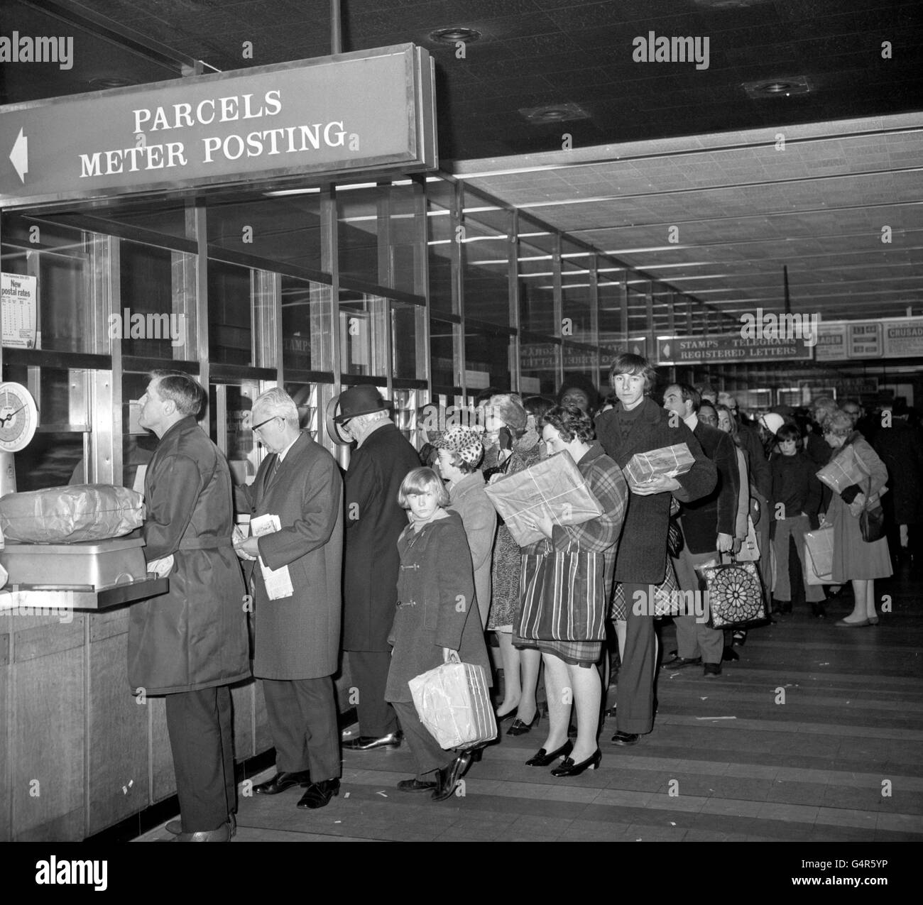 People queue in the Trafalgar Square post office for longer than usual in their bid to beat the last minute Christmas parcels rush. The Post Office restrictions, caused by the rail go slow, comes into force tomorrow. Lord Peddie, chairman of the Post Office Users National Council, said the parcels ban was necessary to ensure letters and cards got through for Christmas Stock Photo