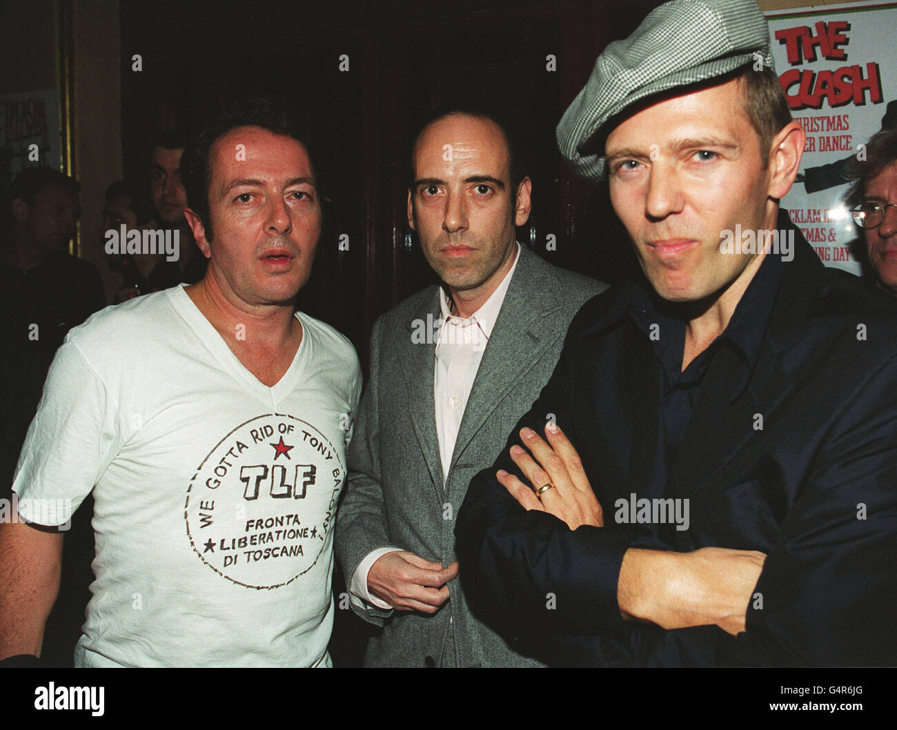 MARCH 18: On this day in 1977, The Clash released their first recording, 'White Riot'. Their former singer, guitarist and songwriter, Joe Strummer, died last year at the age of Fifty. Three members of The Clash (from left), Joe Strummer, Mick Jones and Paul Simonon at the premiere of the BBC2 documentary 'Westway To The World' in Notting Hill in London. The film is about the career of the band, who split in 1986. Stock Photo