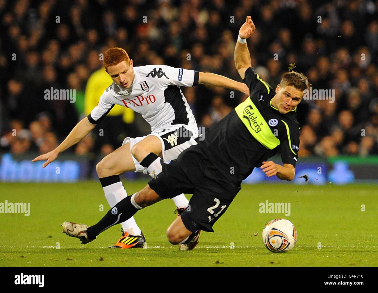 Fulham's Marcel Gecov (left) and Odense BK's Rurik Gislason battle for the ball Stock Photo
