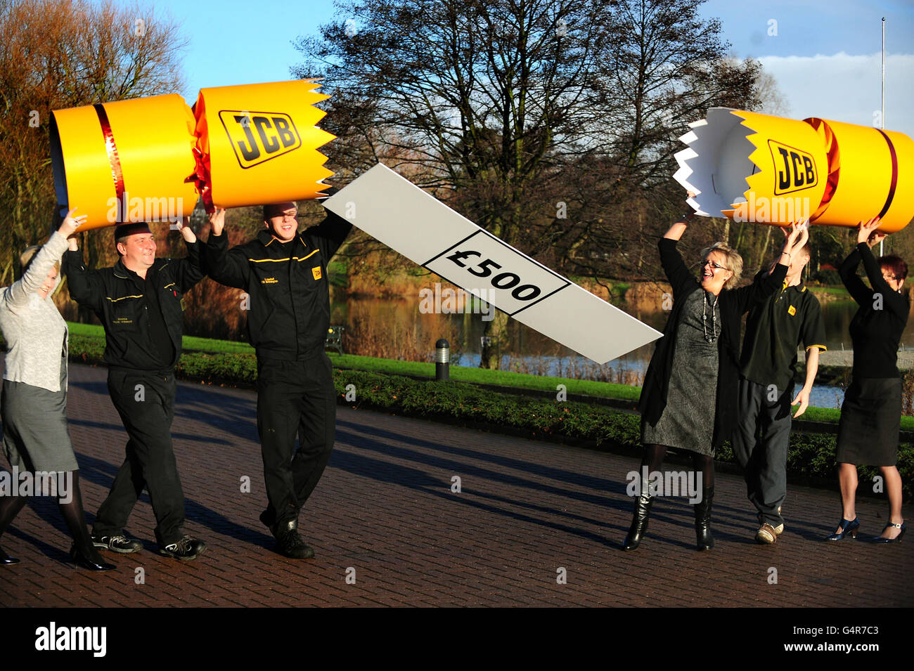 JCB employees celebrate after the company announced a £500 Christmas bonus and a 5.2 per cent pay increase, at JCB HQ in Rocester. Stock Photo
