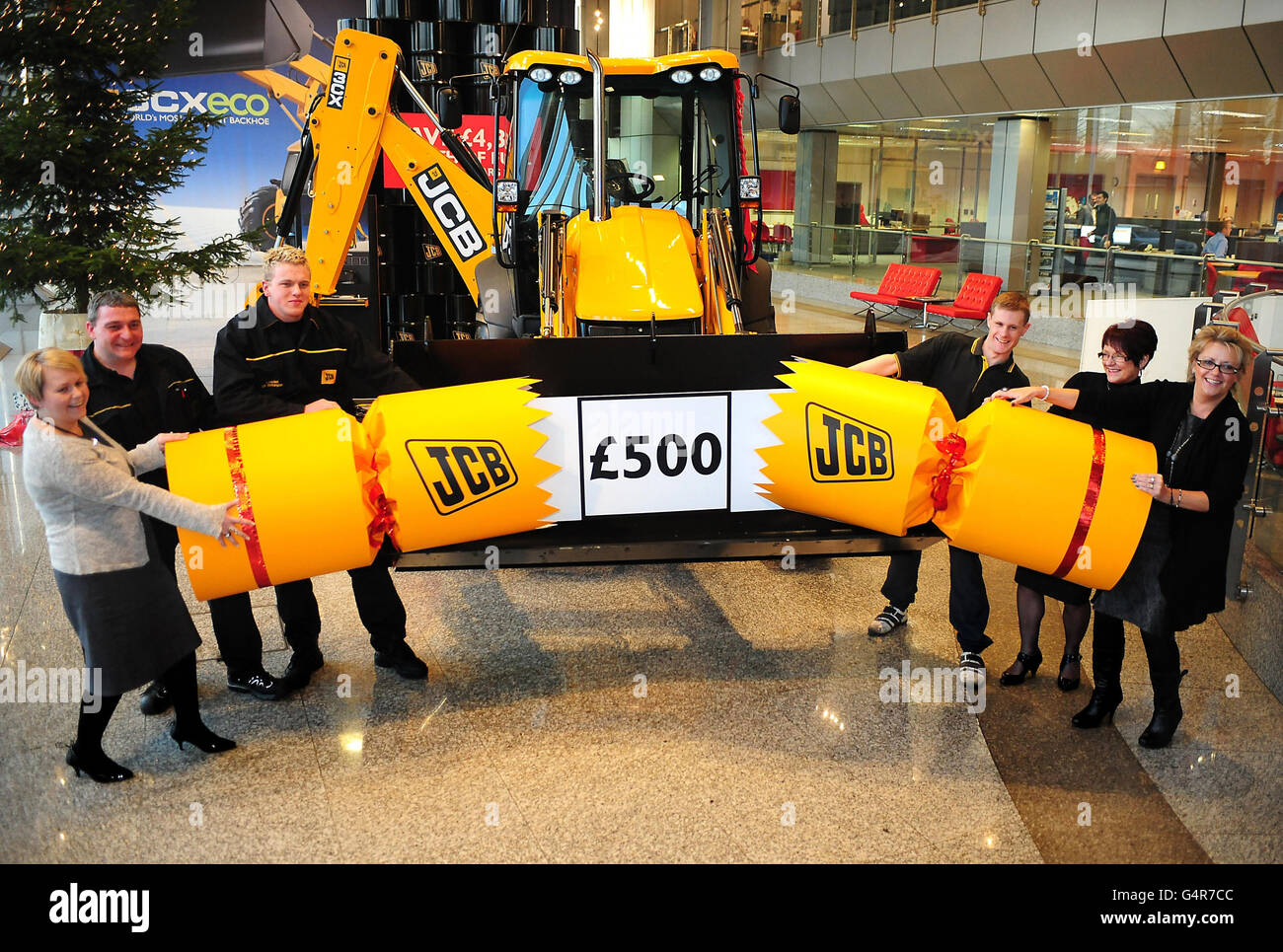 JCB employees celebrate after the company announced a &pound;500 Christmas bonus and a 5.2 per cent pay increase, at JCB HQ in Rocester. Stock Photo