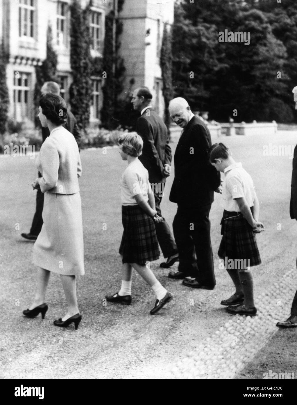 American President Dwight D. Eisenhower walks with Queen Elizabeth II, the Duke of Edinburgh, Princess Anne and the Prince of Wales at Balmoral. Also in the group is Major John Eisenhower, behind the Queen. Stock Photo