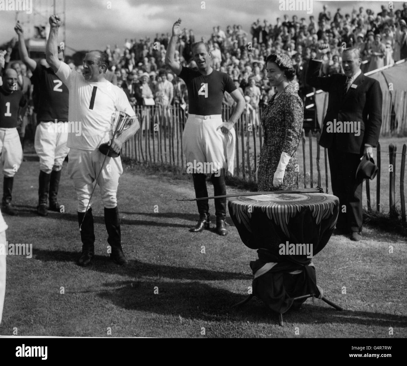 The Duke of Edinburgh (no. 4) joins in three cheers for the Queen, led by A.G Boyd Gibbins (no.1, wearing white) at Smith's Lawn, Windsor Great Park, after the Duke of Edinburgh captained the Windsor Park team to a draw against Silver Leys. Stock Photo