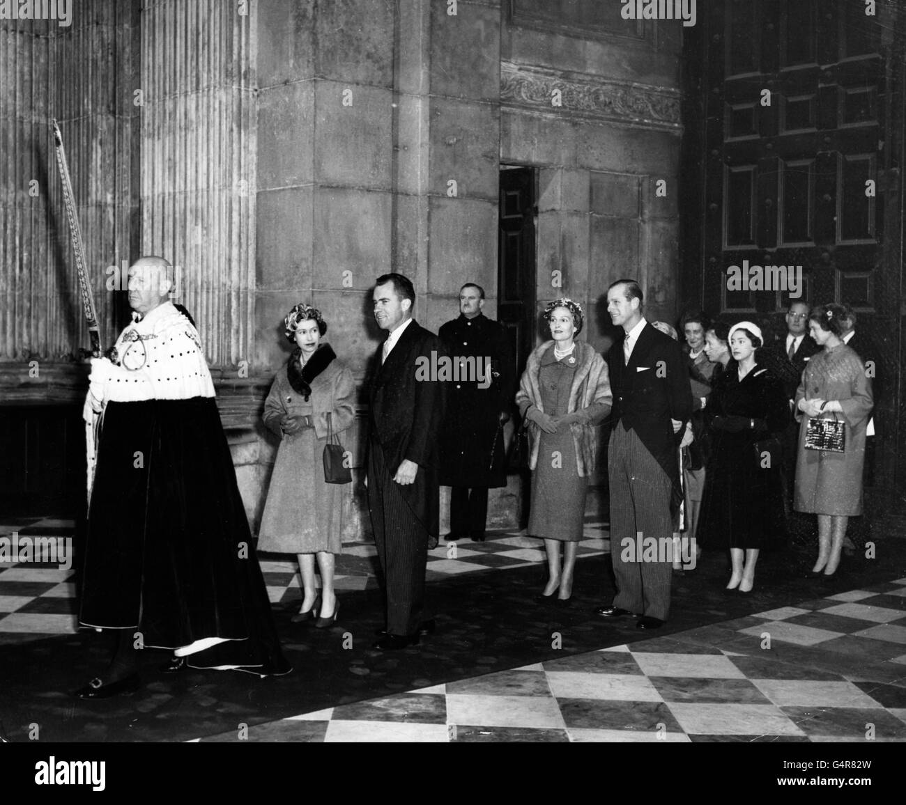 Queen Elizabeth II and American Vice-President Richard Nixon, in procession through St. Paul's Cathedral, London, for the dedication of the American Memorial Chapel. At the head of the procession is the Lord Mayor of London, Sir Harold Gillett. Following the Queen are the Duke of Edinburgh and Pat Nixon; Princess Margaret; the Duchess of Kent; the Princess Royal; Princess Alexandra; and John Hay Whitney, American Ambassador. Stock Photo