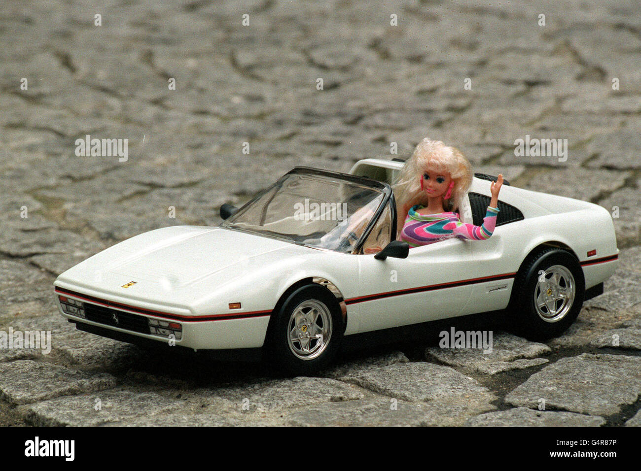 Barbie is giving up her flashy Italian Ferrari in favour of a sporty pink  Jaguar in London Stock Photo - Alamy