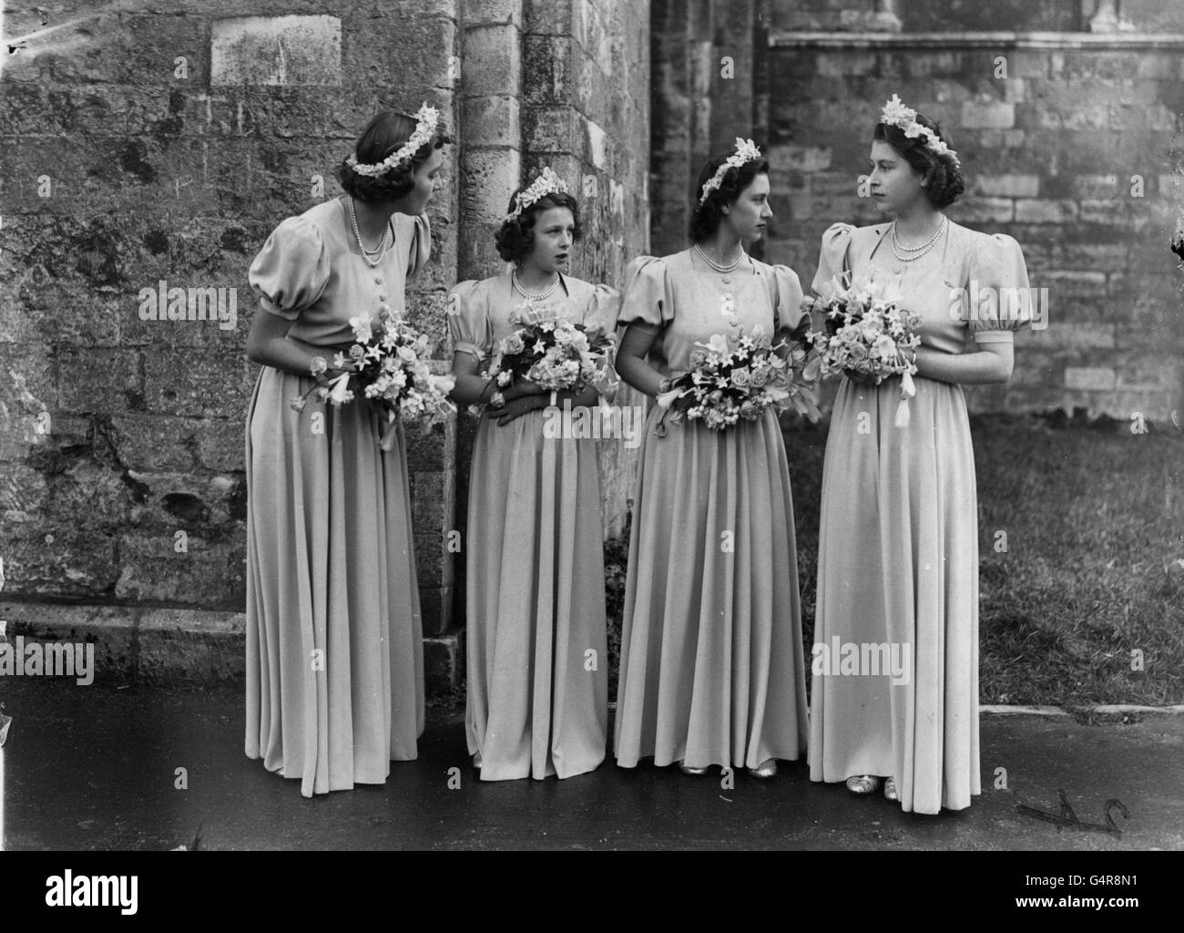 The bridesmaids at the wedding of Honourable Patricia Mountbatten and Lord Brabourne. (L-R) The Hon. Pamela Mountbatten, sister of the bride, Princess Alexandra of Kent, Princess Elizabeth and Princess Margaret at Romsey Abbey. Stock Photo