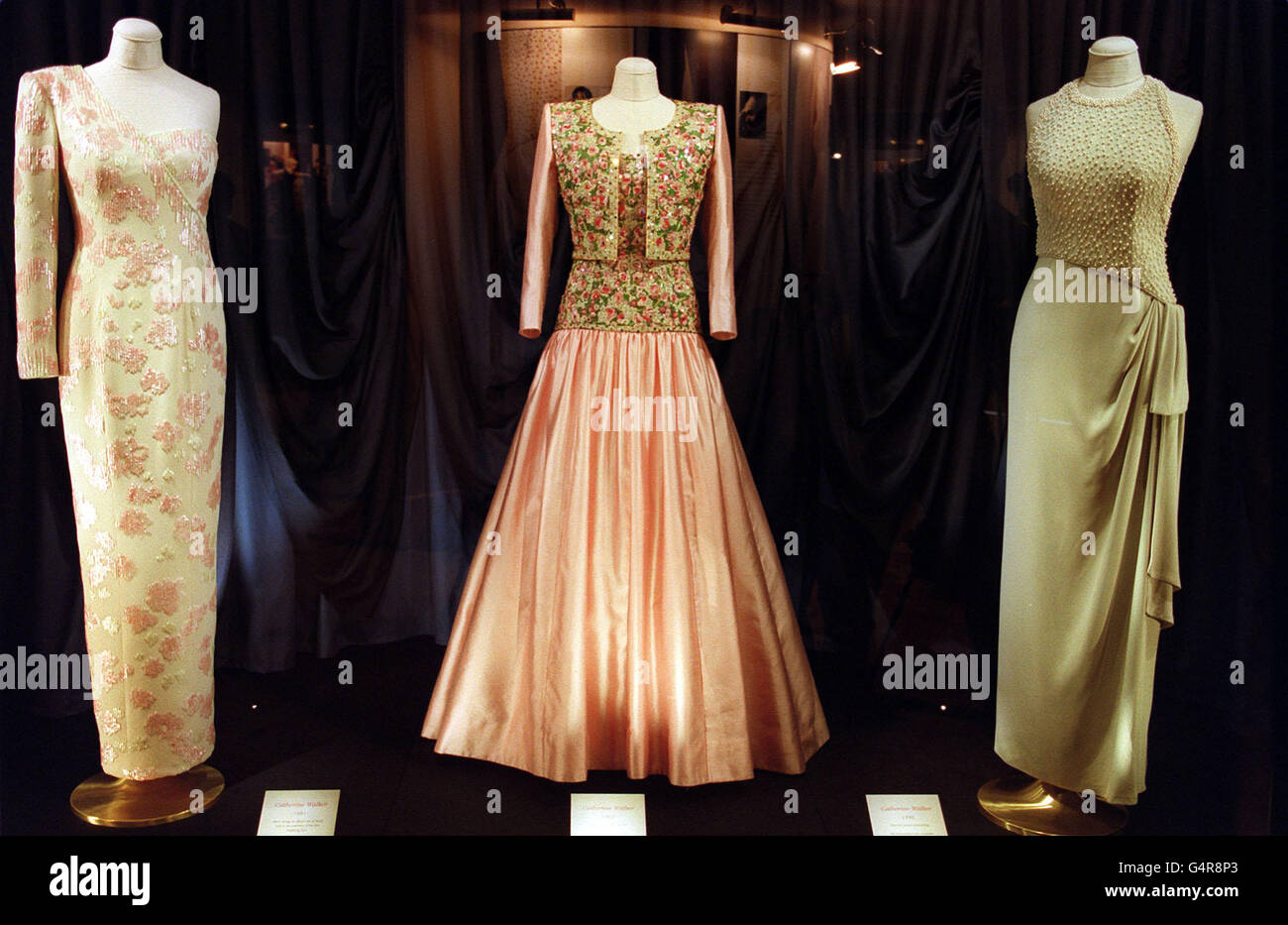 Diana's Dresses: Dresses created by designer Catherine Walker, worn by Diana, Princess of Wales. The dresses are on loan from the People's Princess Charitable Foundation, established by Maureen Rorech, who bought them at a Christie's auction in 1997. The dress in the centre (1992) was designed for the Princess' tour of India, while the dress on the right was worn to private functions. Stock Photo
