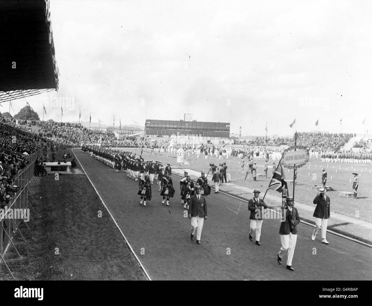 PA News Photo July 5th 1924: The Olympic Games open in Paris. British Athletes marching past the Royal stand in the Colombes Stadium. Stock Photo