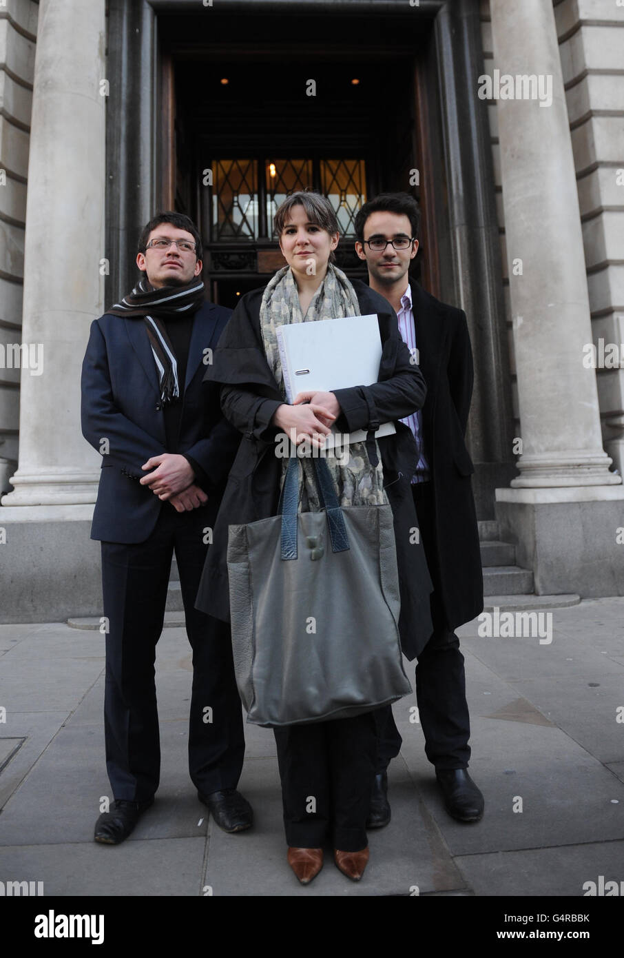 Rosa Curling, Lucas Fear-Segal (right) and Timothy Street (left) serve papers to the HMRC on behalf of UK Uncut Legal Action in London today. Stock Photo