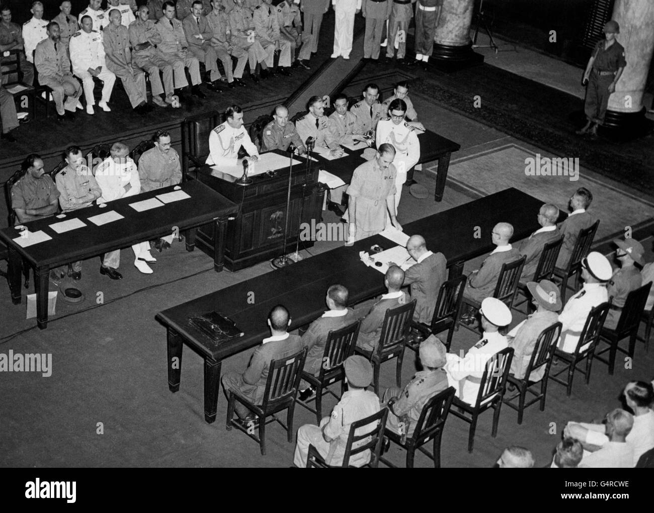 Lord Louis Mountbatten, Commander of the Allied forces in South East Asia, presides as General Itagaki of the Japanese Imperial Army signs the surrender document in Singapore. Stock Photo