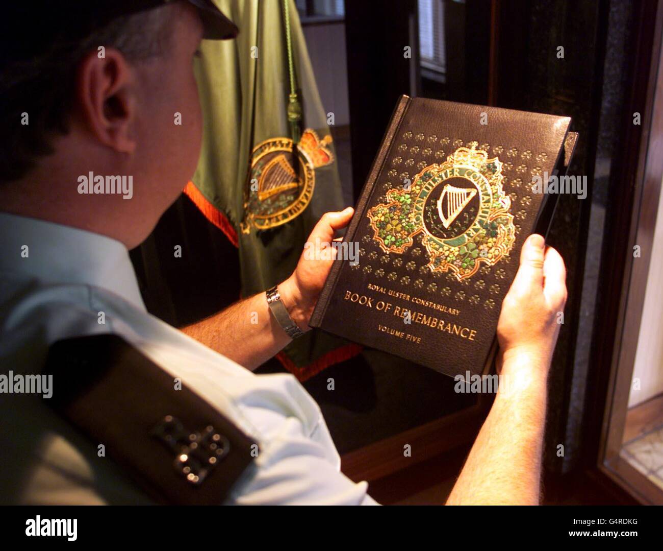 A RUC (Royal Ulster Constabulary) man looks over the police book of remembrance at RUC headquarters Belfast, which contains the names of officers killed in the line of duty. The last entry was of constable John Graham, killed in Lurgan by the IRA in 1997. Stock Photo