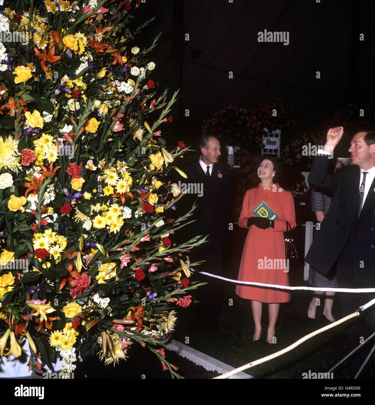 Queen Elizabeth II admires a colourful display during her visit to the ...