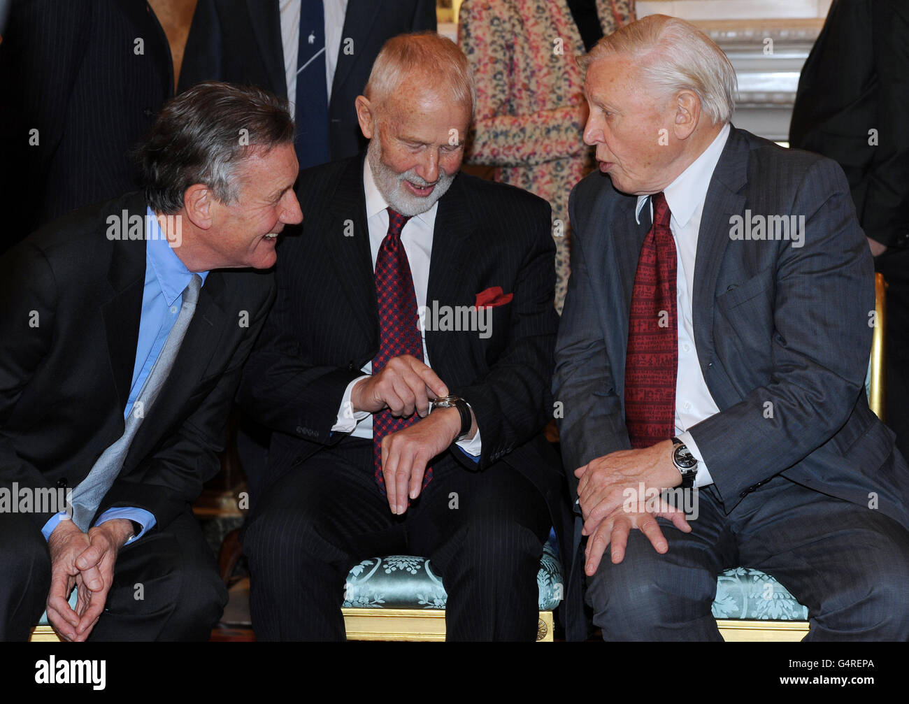 Michael Palin speaks with Sir Chris Bonington and Sir David Attenborough as the Queen and Duke of Edinburgh host a reception to celebrate exploration and adventure at Buckingham Palace, London Stock Photo