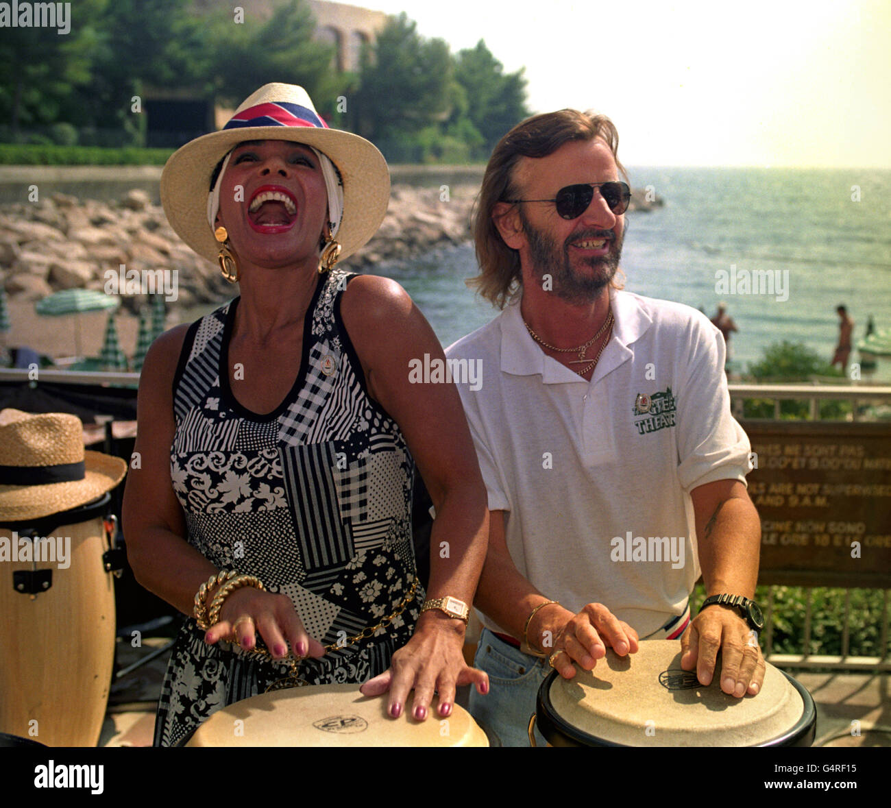 Singer Shirley Bassey joins Ringo Starr on the Bongos at a beach party in Monte Carlo to promote Manchester's Olympic bid. It was unsuccessful. Stock Photo