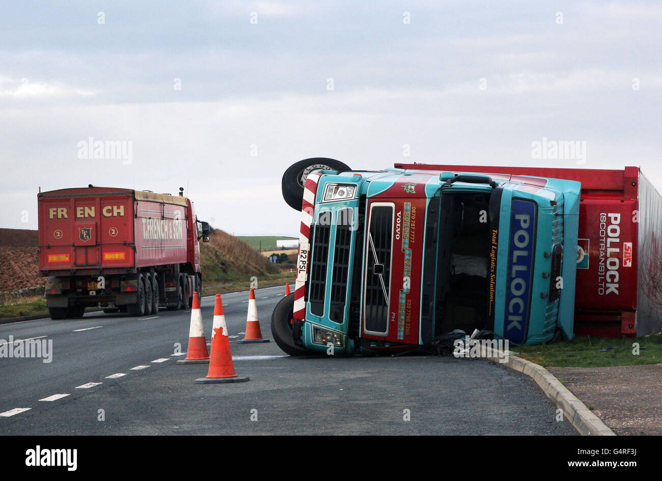 A lorry near Dunbar, Scotland, is seen on its side after hurricane-force winds closed schools, cut off power to tens of thousands of homes, and forced rescue missions in parts of Britain. Stock Photo