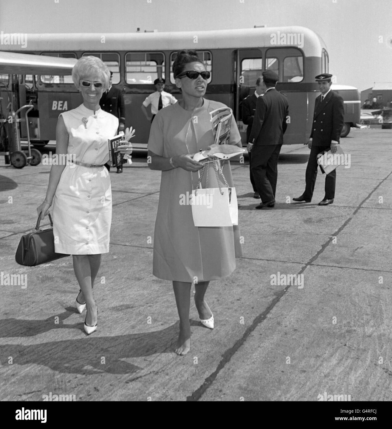 Singer Shirley Bassey, who recently tripped and lost her shoe at London Airport, had similar trouble today when her heel caught, and stuck fast in the melting tar on the apron at Heathrow. Undeterred, she walked on, with only one shoe. She was off to Palma, where she is appearing in Titos Club. Stock Photo