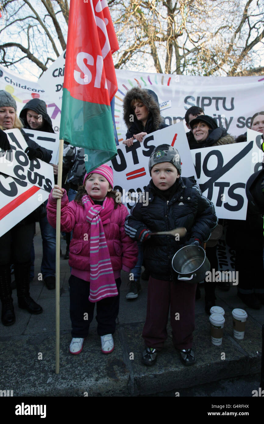 Sarah Kay Downes (left), aged four, and Kyle Burke McMahon (right), aged five, join protesters outside Leinster House to demonstrate over cuts to Community Employment Schemes. Stock Photo