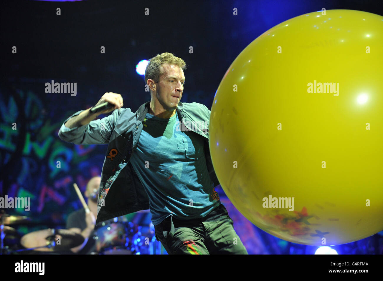 Chris Martin of Coldplay performs as they promote their fifth studio album, Mylo Xyloto, released earlier this year, at The O2 Arena, Greenwich, south London. Stock Photo