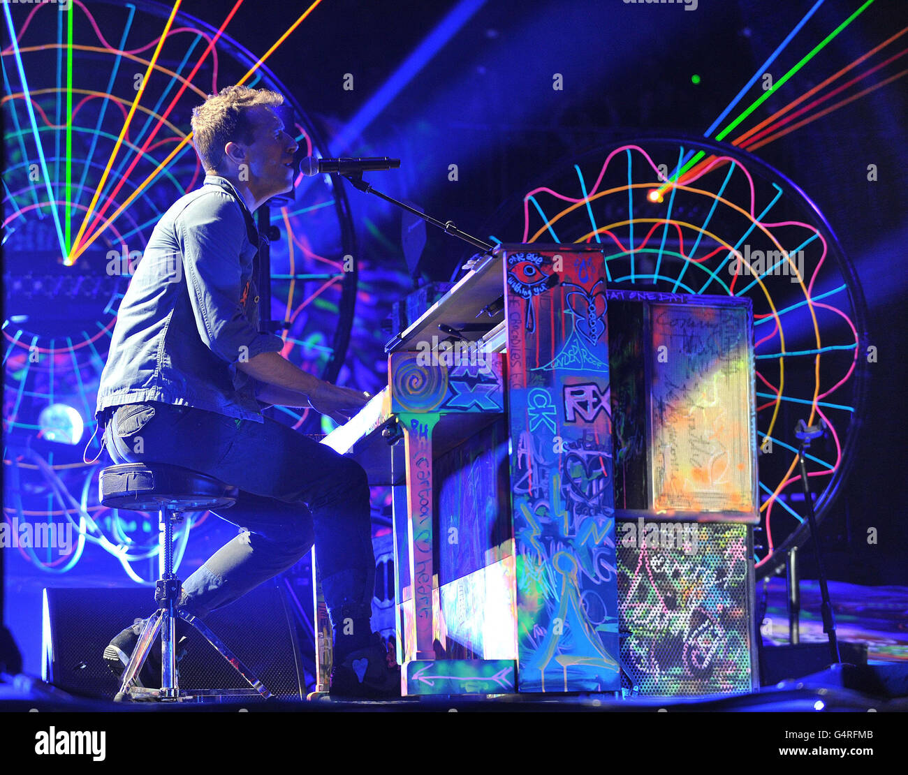 Chris Martin of Coldplay performs as they promote their fifth studio album, Mylo Xyloto, released earlier this year, at The O2 Arena, Greenwich, south London. Stock Photo