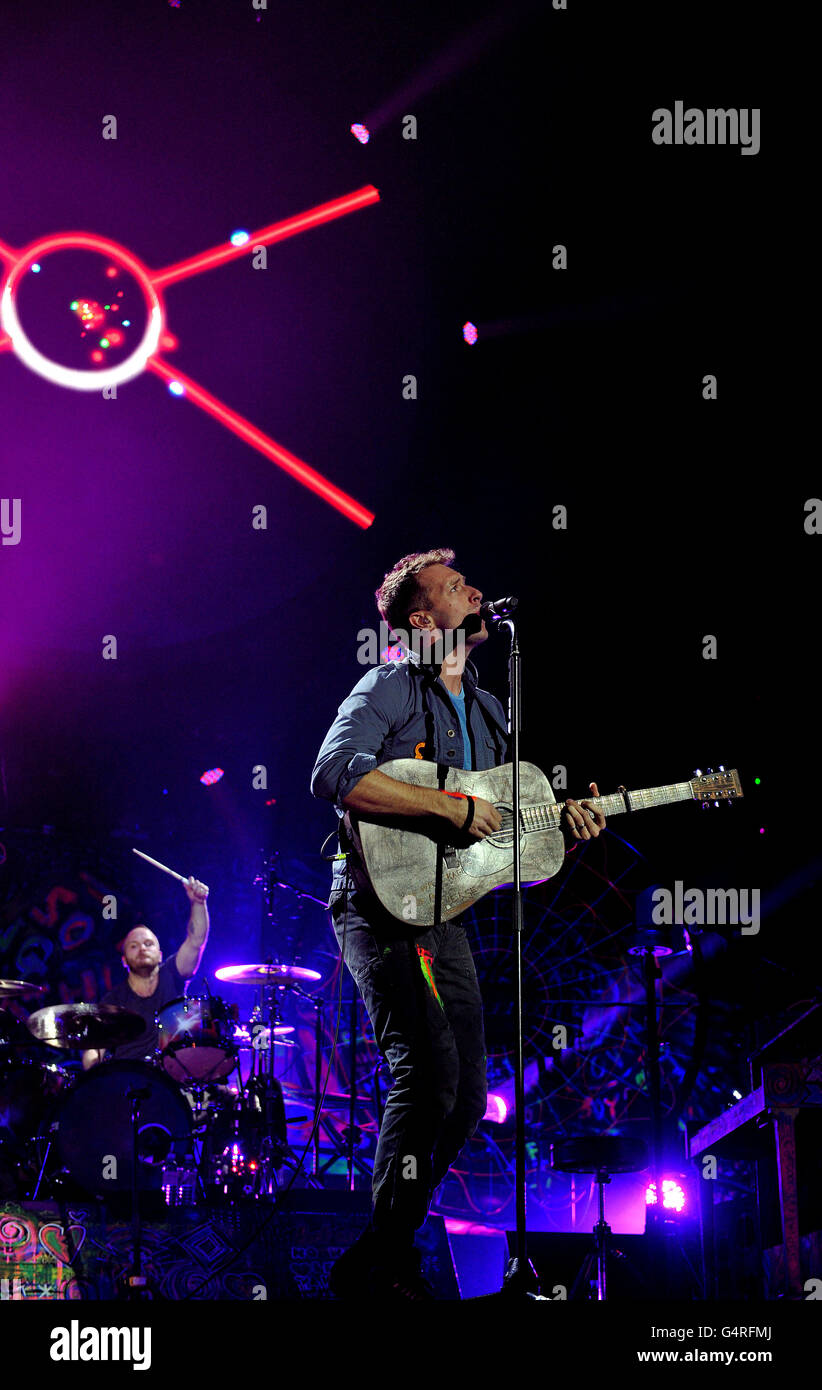 Chris Martin (front) and Will Champion of Coldplay performs as they promote their fifth studio album, Mylo Xyloto, released earlier this year, at The O2 Arena, Greenwich, south London. Stock Photo