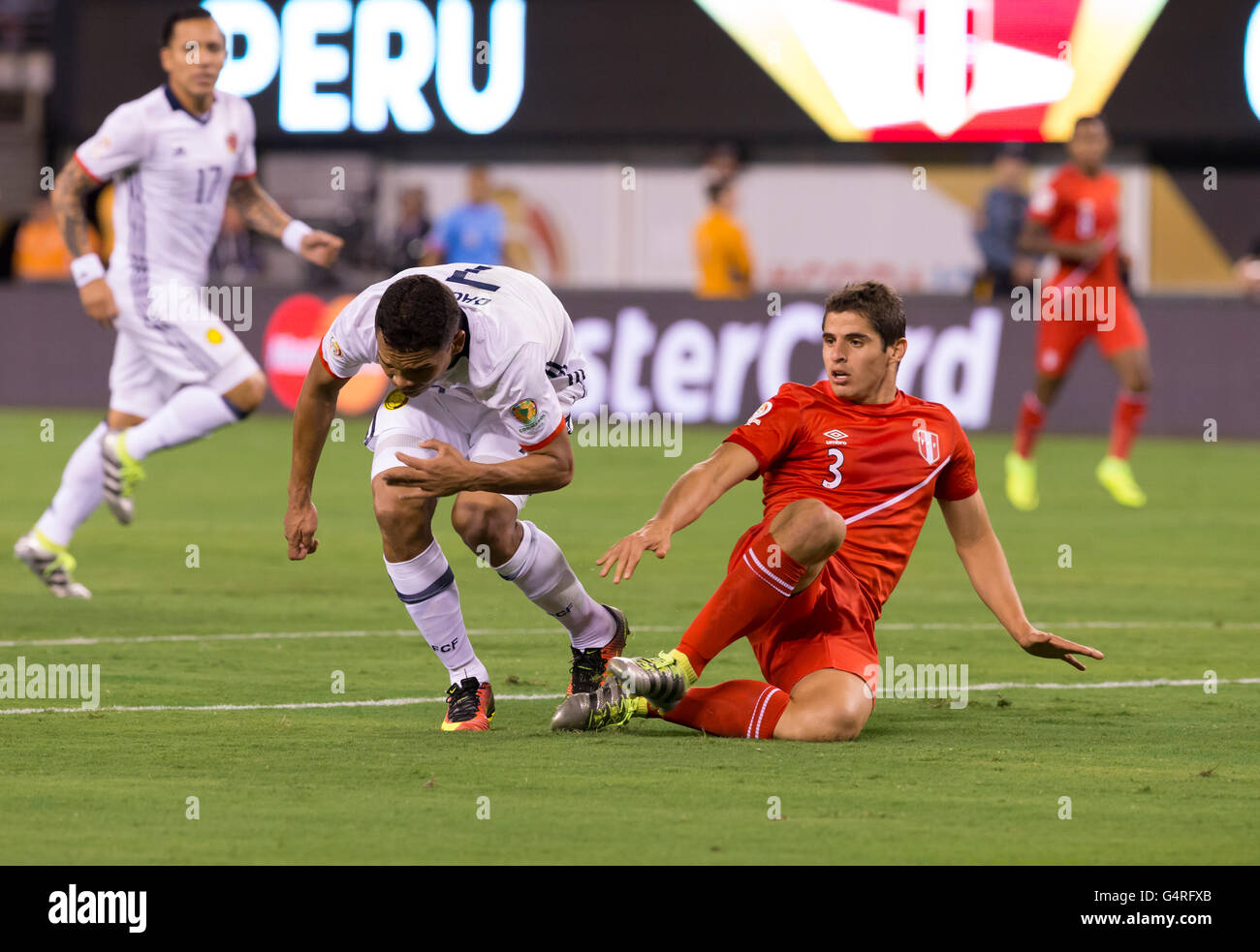 East Rutherford, NJ USA - June 17, 2016: Carlos Bacca (7) of Columbia & Aldo Corzo (3) of Peru collide  during quaterfinal game between Columbia & Peru. Columbia won 0 (4) - 0 (2) by penalty kick Stock Photo