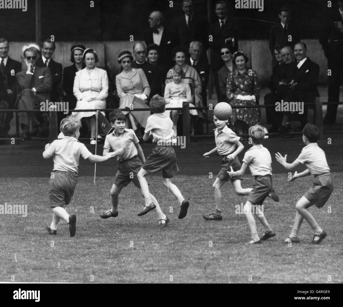 Prince Charles (second from left) playing handball at the Hill House School sports day, watched by the Duke of Edinburgh, Queen Elizabeth II and Princess Anne Stock Photo